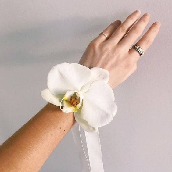 orchid on wrist wedding favor